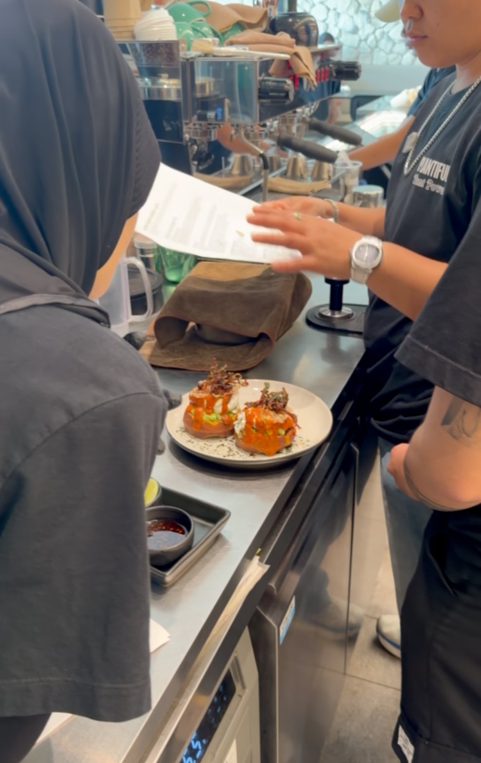 Team briefing and training — recipe in hand, dish on the pass
